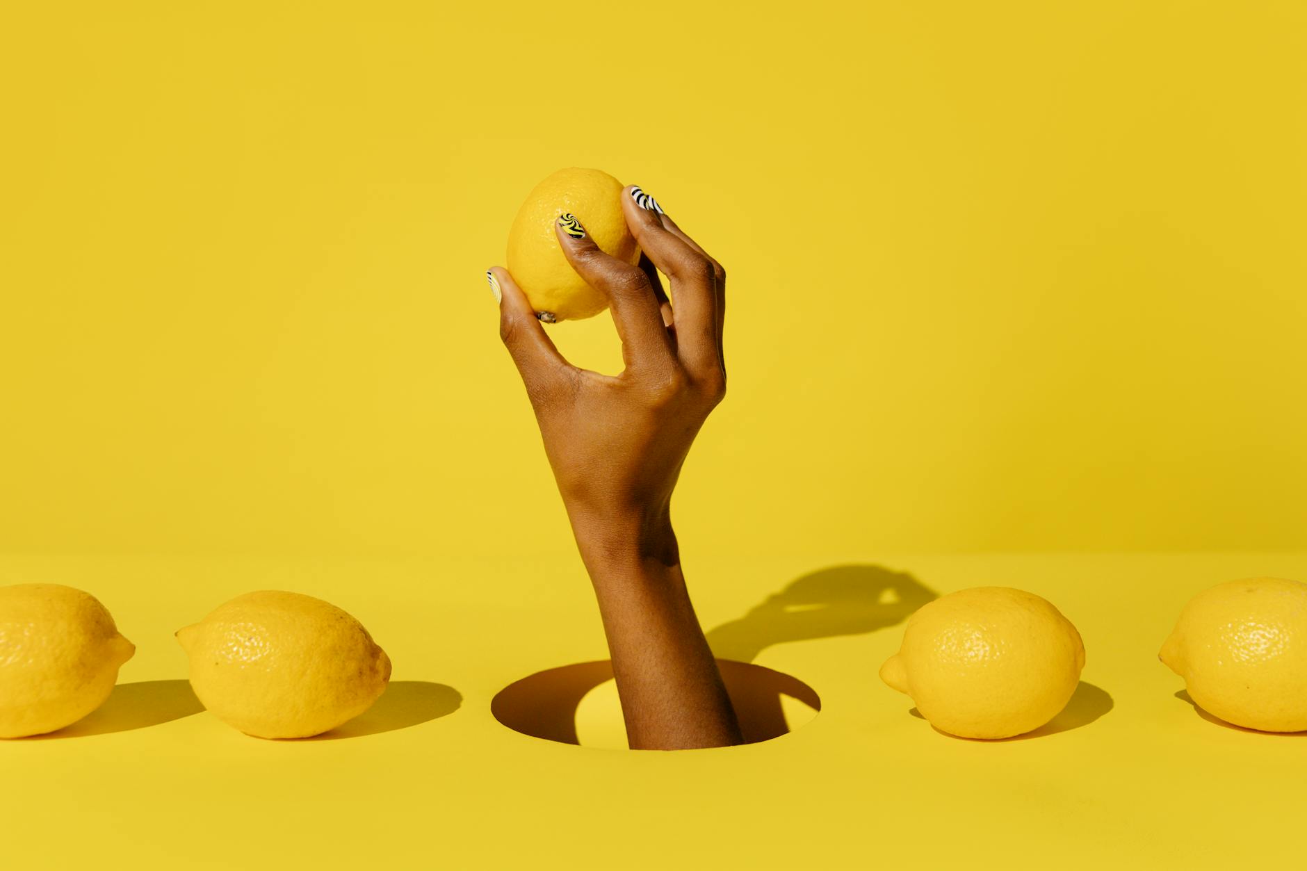 Close-up of hands gently holding a blue lemon vibrator, symbolizing careful, mindful pleasure during recovery