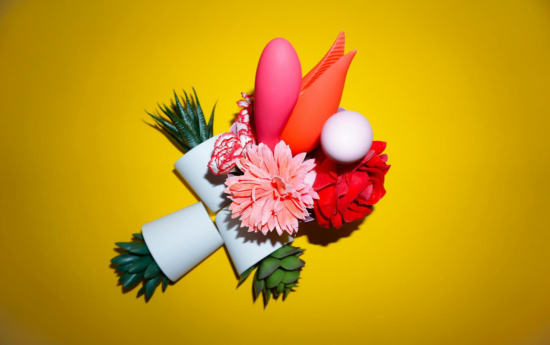Bright lemon vibrators arranged on a pastel background, representing fresh approaches to pleasure